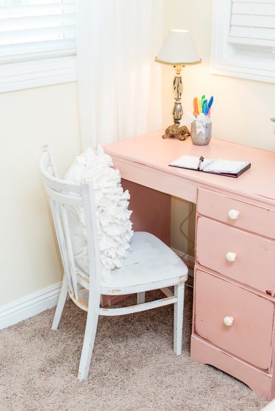 This desk was painted in a custom color mix of Antoinette, Scandinavian Pink and Pure White to pull the soft blush pink color that is found in her cozy duvet. The edges got sanded back lightly and the slight hint of red in the base coat of the desk compliments the deeper reds and burgundy found on the hand-painted mural on the wall.