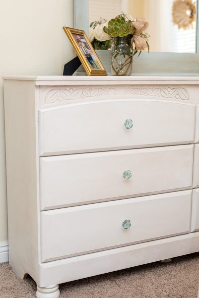 The bed and low boy dresser received fresh coats of Pure White Chalk Paint® with a very soft highlighting of dark wax around the edges.